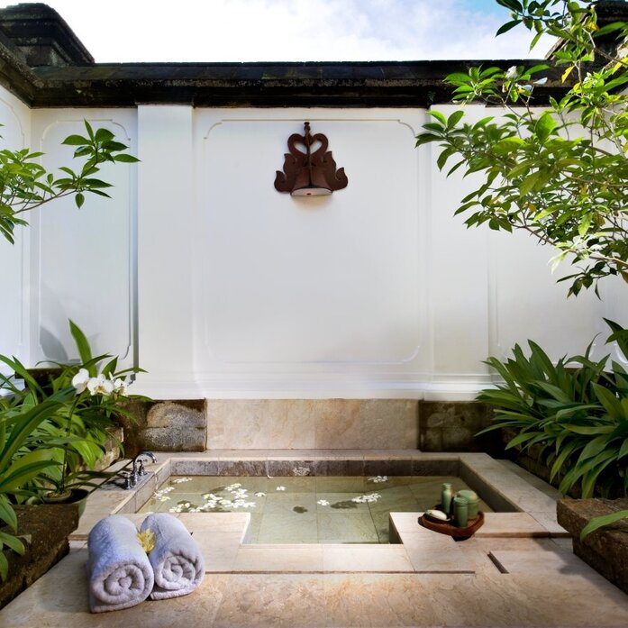 Sunken bath surrounded by tropical plants in a garden pavilion at Amandari resort, Indonesia.