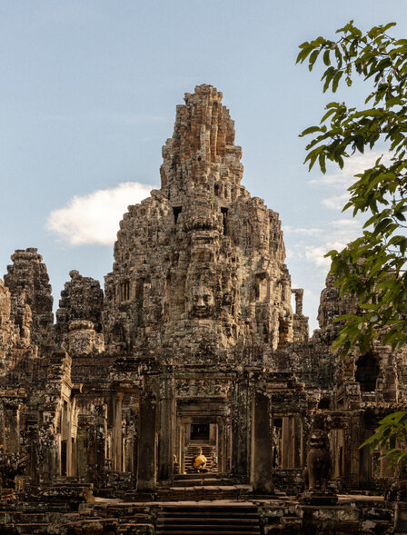Bayon temple's central towers rise above surrounding trees at Amansara's Angkor temple location.