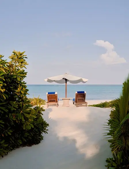 Grand Beach Pool Casita at Amanpulo, Philippines, with loungers and umbrella facing the sea.