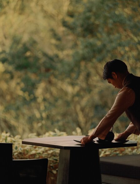 Staff member arranging amenities at Amanemu, Japan.