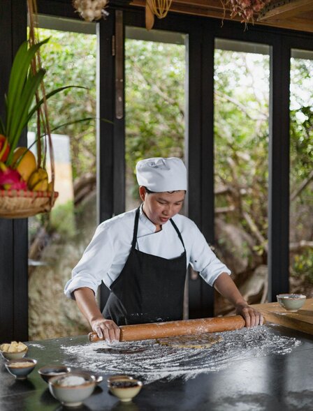 Chef preparing ingredients at Amanoi's cooking class in Vietnam.