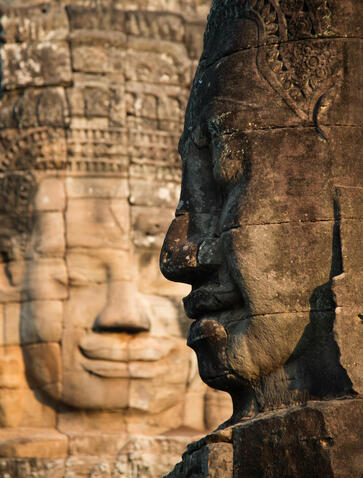 Stone carved faces at Amansara's multi-destination destination, showcasing regional heritage and artistry.