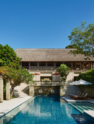 Five-bedroom villa at Aman Villas at Nusa Dua with infinity pool and thatched-roof pavilion.