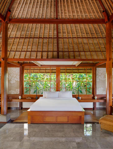 Village Suite bedroom at Amandari with alang-alang thatch roof and open pavilion design.