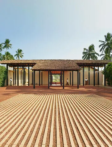 Amanwella entrance pavilion with striped timber deck and palm trees, Sri Lanka.