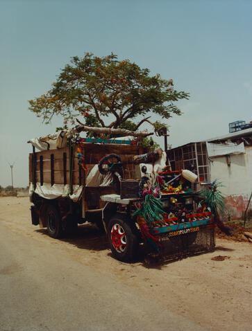 Colourful truck parked beneath a spreading tree at Amanbagh, India.