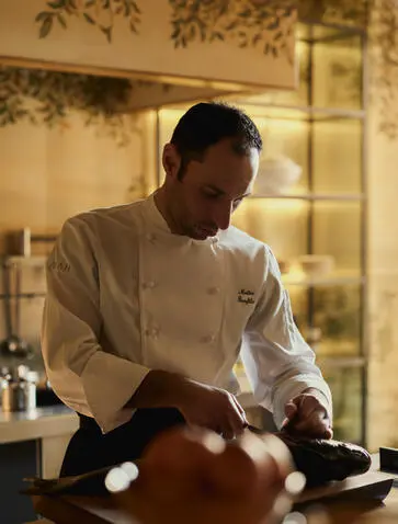 Chef preparing a meal in the Palazzo kitchen at Aman Venice.
