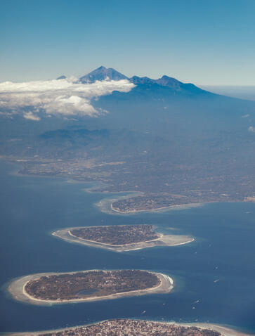 Aerial view of Amanwana's volcanic islands emerging from the Flores Sea, Indonesia.