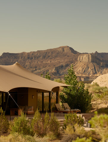 Camp Sarika at Amangiri, with canvas tent and desert mountains at sunset.