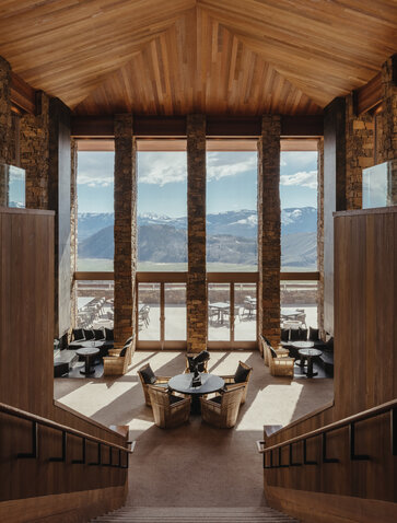 Amangani's lobby features wooden panelling and large windows framing views of Wyoming's landscape.