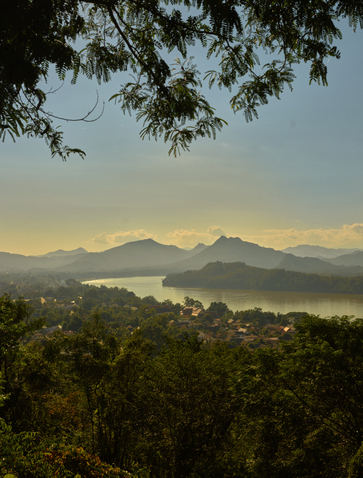 Aerial view from Phousi Temple viewpoint towards distant mountains and Luang Prabang at Amantaka, Laos.