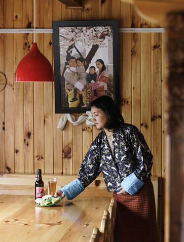 Guest enjoying local cheese and beer in Bumthang, Bhutan at Aman.