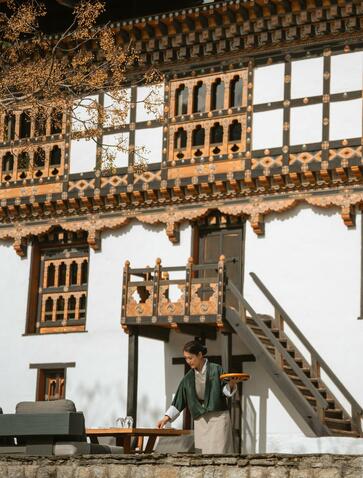 Ornate wooden architecture of Amankora's Punakha property, featuring traditional Bhutanese design with intricate carved details and painted timber framing.