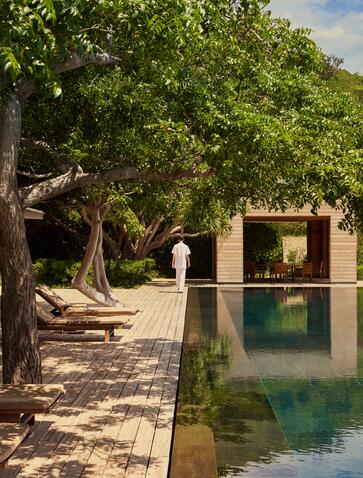 Five-bedroom bay pool residence exterior at Amanoi, Vietnam, with water channel and shaded courtyard.