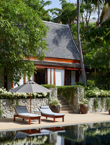 Aerial view of a three-bedroom garden villa at Amanpuri resort in Thailand, with lush landscaping and a reflecting pool.