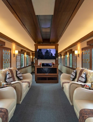 Train carriage interior at Amanjiwo resort with cream seating and warm lighting.