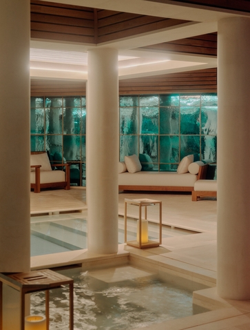 Spa wellness pool at Aman Le Mélézin with floor-to-ceiling windows overlooking the French Alps.
