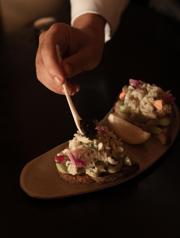 Chef plating Mediterranean cuisine at Amanpuri, Thailand, with fork and plate detail.