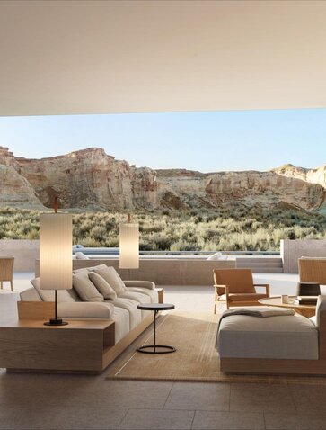 Amangiri residence living room overlooking desert landscape and mountains through floor-to-ceiling windows.