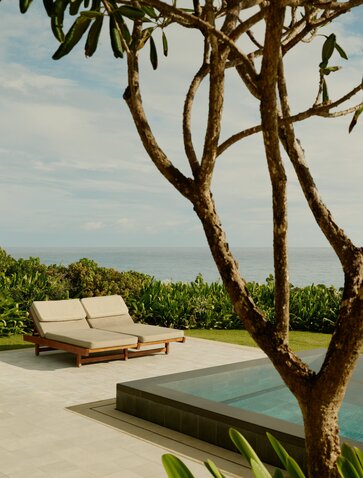 Casita terrace with lounger beneath curved tree overlooking Dominican landscape at Amanera.