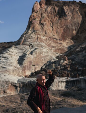 Geshe La stands before a towering rock formation at Amangiri resort, Utah.