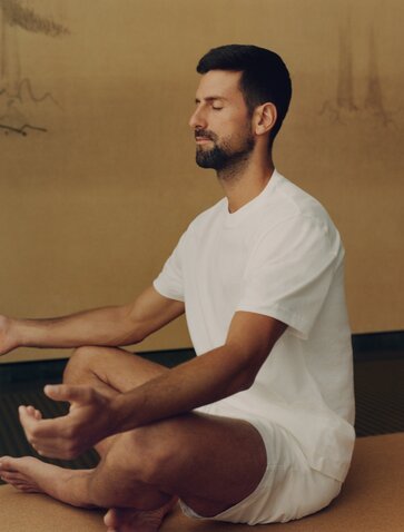 Novak Djokovic meditating in a serene studio space at Amanoi.