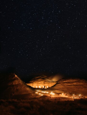 Amangiri's illuminated desert landscape beneath a starlit night sky.
