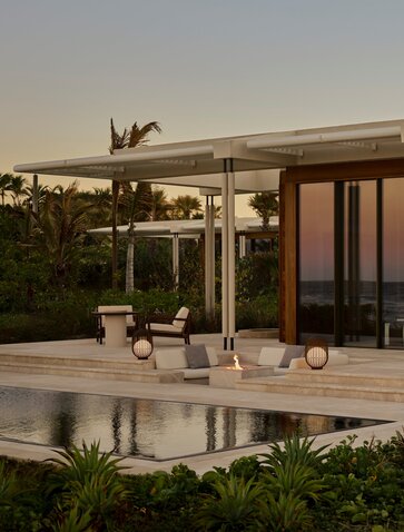 Beachfront casita terrace at sunset with dining area and ocean views, Amanvari, Mexico.