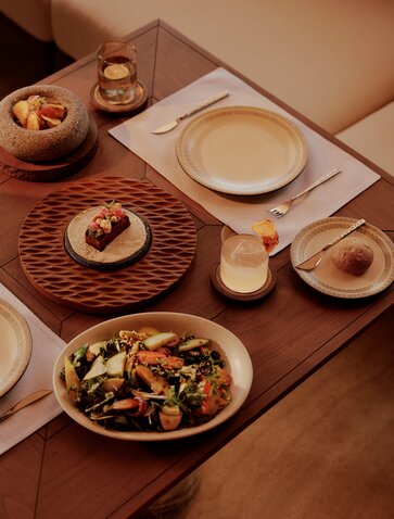 Amanvari beach club dining table with Mexican-inspired dishes and earthenware serving pieces.