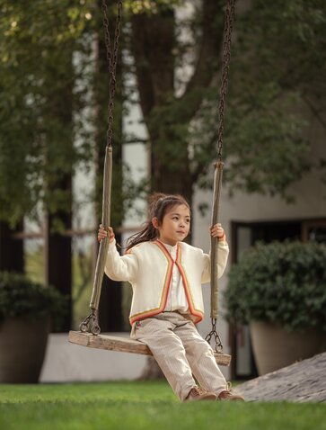 Family member relaxing beneath tall trees at Amanyangyun, Shanghai.
