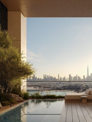 External terrace at Aman Residences Dubai with city skyline view across the water.