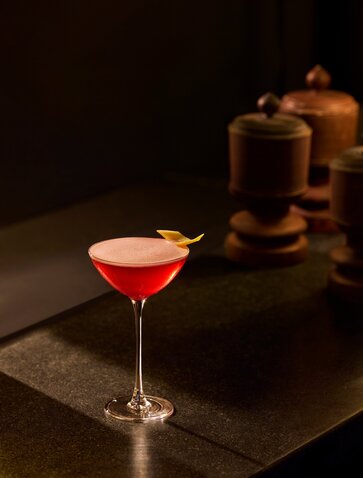 Cocktail with crimson liqueur and garnish at Amanoi's bar, Vietnam.
