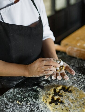 Chef's hands shaping dough during a cookie-making class at Amanoi, Vietnam.