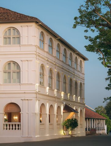 Amangalla's cream-coloured colonial exterior with arched windows and balustrade terrace.