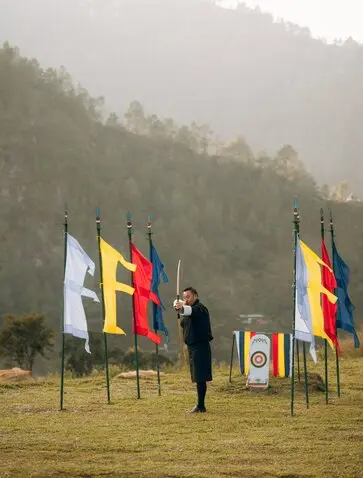 Archer practising with traditional Bhutanese flags at Amankora's Punakha Lodge.