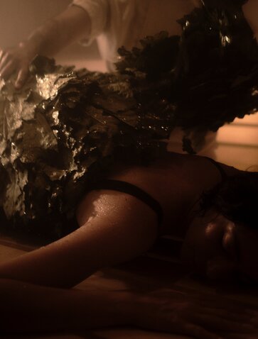 Wellness ritual in the banya at Amanvari, Mexico, with steam rising around a guest in warm candlelit tones.