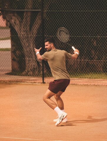 Novak Djokovic playing tennis on a clay court at Amanjena, Morocco.