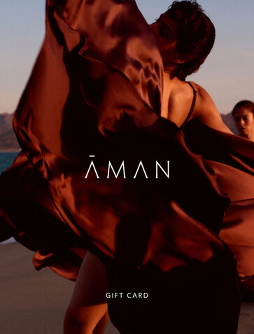 Amanvari festive gift card with terracotta silks and warm sunset light.