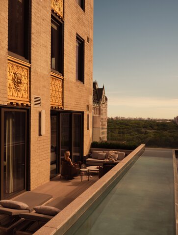 Three-bedroom home with pool at Aman New York, terrace at sunset.