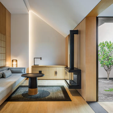 Contemporary bathroom at Amanyangyun with wooden accents, sunken soaking tub, and garden views.