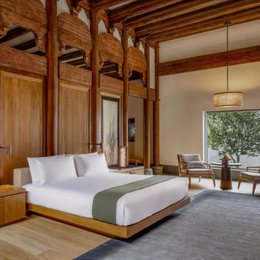Principal bedroom at Amanyangyun with wooden architectural frames and garden views.