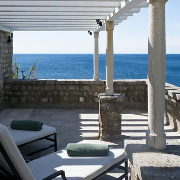 Adriatic Suite terrace at Aman Sveti Stefan with sunlounger overlooking the Adriatic Sea.
