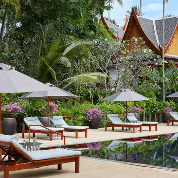 Four-bedroom garden villa with sunbeds and plunge pool overlooking tropical grounds at Amanpuri resort, Thailand.