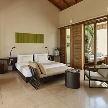 Garden Pool Suite principal bedroom at Amanwella, Sri Lanka, with bed and garden views.