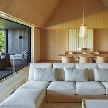 Mori Villa at Amanemu resort features a light-filled living space with wooden ceilings, neutral furnishings, and garden views through open doors.