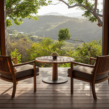 Mountain Pavilion at Amanoi framing views of terraced Vietnamese valleys through open doors.