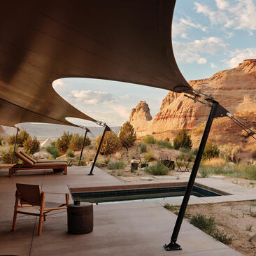 One-bedroom pavilion at Amangiri with shaded seating area overlooking red rock desert landscape.