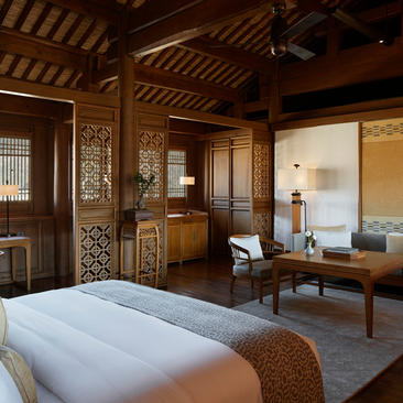 Principal bedroom at Amandayan with carved wooden screens and traditional Chinese design elements.
