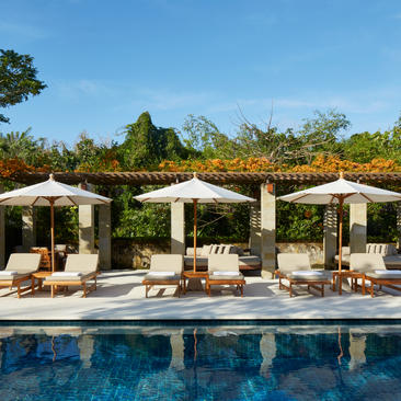 Six-bedroom villa with pool and pergola-shaded lounging areas at Aman Villas at Nusa Dua.