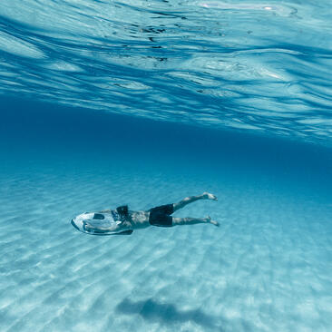 Snorkeller floating in clear turquoise waters at Amanyara.